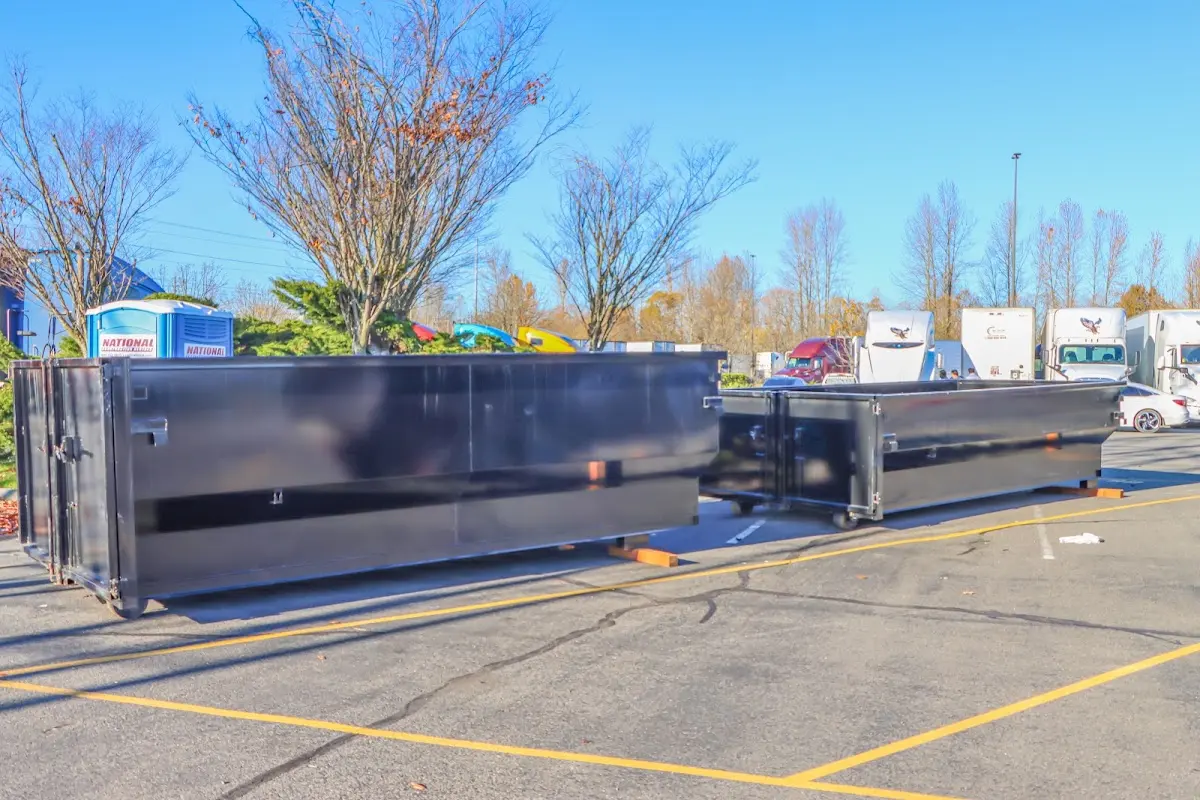 Professional dumpster rental service with roll-off container on residential driveway in Moncks Corner